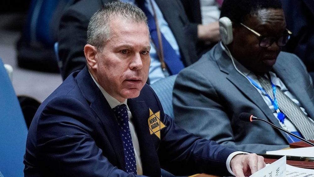 Israel’s U.N. Ambassador Gilad Erdan wears a yellow Star of David that reads "Never Again" in honor of those killed in the unprecedented attack by Hamas, which triggered an ongoing war, as he addresses members of the Security Council.